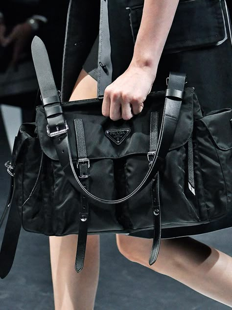 The nylon bag has made a comeback in a big way. From Prada's iconic design to the high-street versions, we've selected the best. Big Prada Bag, Prada Nylon Bag Street Style, Prada Nylon Outfit, Small Bag Outfit, Prada Book, Prada Bag Black, Prada Nylon Tote, Prada Nylon Bag, Shoulder Bag Outfit