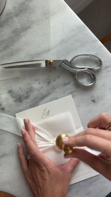 Wedding Invitation Designer | Kate Bessell on Instagram: "Hand pouring wax seals ✨So much care goes into assembling each and every one of my couples invitation suites but the end result is worth it every time. This pairing of pearl white wax seals, silk ribbon, and gold foil creates the most magical experience for guests to open up! YUM" Wedding Invitations Vellum Wrap Ribbon, Wedding Invitation With Ribbon And Wax Seal, Silk Ribbon Invitation, Wedding Invitation Wax Seal Ribbon, Envelope Ribbon Wax Seal, Ribbon Wedding Invitations, Silk Ribbon Wedding Invitations, Pearl Invitations, Ribbon Wedding