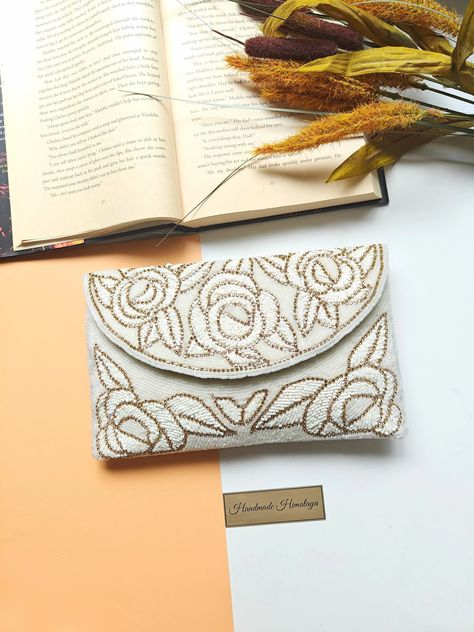 Handcrafted golden-white floral beaded envelope clutch purse featuring intricate beadwork, ideal for bridal occasions, elegant crossbody shoulder bag option, perfect wedding day accessory, unique handmade gift for her Elegant Envelope, Beaded Clutch Purse, Formal Parties, Bridal Accessory, Floral Clutches, Bridal Bag, Bridal Clutch, Embroidery Bags, Envelope Design