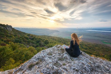 Woman on the top of a hill by Jasmina_K. A woman on the top of a rock enjoys the view of sunset and using digital tablet #Sponsored #Jasmina_K, #woman, #hill, #Woman Woman On Mountain Top, Moiraine Sedai, Landscape House, Best English Songs, Manga Reference, Instagram Feed Ideas Posts, Travel Pictures Poses, Digital Tablet, Flower Landscape