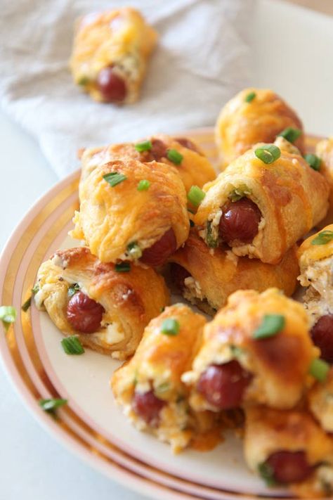 Pigs in a blanket have been my happy bite all my life. In my family these flaky, doughy salty treats show up every holiday and special occasion. Also, they are crazy easy to make. Make these the day before and cook them right before guests arrive. Happy Cooking! #pigsinablanket #appetizers #quickfood #makeahead Popper Pigs In A Blanket, Tailgate Recipes, Homemade Appetizer, Salty Treats, Happy Cooking, Jalapeno Popper, Fast Dinners, Pigs In A Blanket, Easy Comfort Food