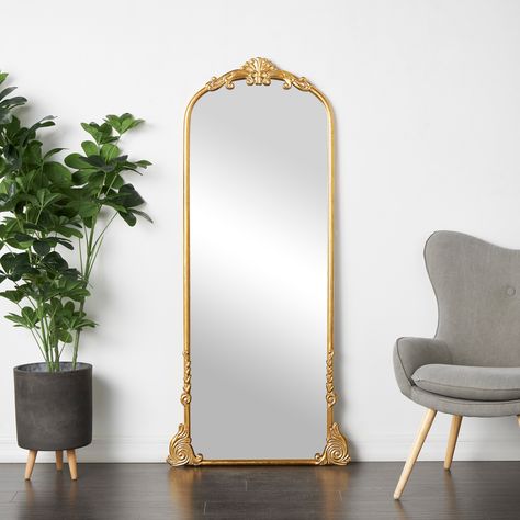 Place this ornate wall or floor mirror in a sunlit parlor or at the end of an elegant corridor, its radiant reflections and intricate detailing will create an enchanting focal point. This item ships in 1 carton. Floor Mirror Decor, Gold Floor Mirror, Barbie Things, Tall Mirror, Golden Mirror, Golden Wall, Kelly Clarkson Home, Floor Runners, Large Wall Mirror