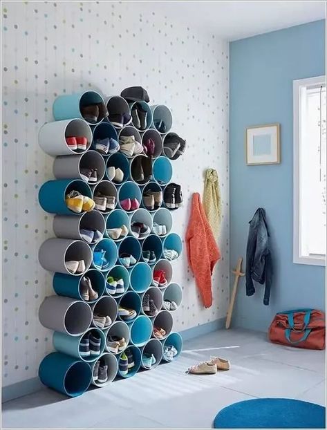 Make Shoe Storage from PVC Pipes123 Creative shoe storage solution using cylindrical shelves in a modern and colorful room with coats and bags hanging nearby. | Sky Rye Design Organization Ideas For Toys, Pvc Pipe Storage, Room Storage Organization, Toddler Room Organization, Kids Room Storage, Extra Space Storage, Toy Storage Solutions, Storage Room Organization, Storage Kids Room