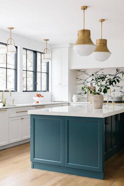 Polished brass faucets are fixed to a glossy white countertop over a sink finishing a peacock blue island lit by two Kelly Wearstler Precision Pendants. Home Kitchen Decor Ideas, Kitchen Island Finishes, Reno Kitchen, Black Mosaic Tile, Dark Blue Kitchens, Blue Kitchen Island, Kitchen Island Tops, Light Grey Kitchens, Kitchen Peninsula