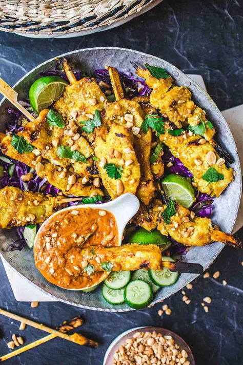 This recipe for Chicken Satay is bursting with authentic Thai flavor! Chicken (or tofu) is bathed in a fragrant marinade of coconut milk and Thai spices, then grilled to perfection and served with a flavorful peanut dipping sauce.  Vegan-adaptable! Satay Tofu, Peanut Sauce Chicken, Thai Chicken Satay, Chicken Satay Recipe, Peanut Dipping Sauce, Thai Spices, Peanut Dipping Sauces, Recipe For Chicken, Chicken Satay