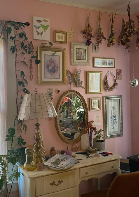 @aysia_arnold pink bedroom wall ideas fairy core cottage core girly aesthetic bedroom painted walls paintings thrifted antique pictures vintage capiz shell lamp vintage mirror gold accents plants green and pink butterfly aesthetic desk area vanity Girly Antique Bedroom, Bed Rooms Ideas Cottage Core, Fairy Cottage Core Room, Mirror And Painting Wall Decor, Pink Vintage Dresser, Room Ideas Aesthetic Pink Walls, Pink And Green Vintage Bedroom, Pink Room Decor Of Your Dreams, Pink Walls Room Aesthetic