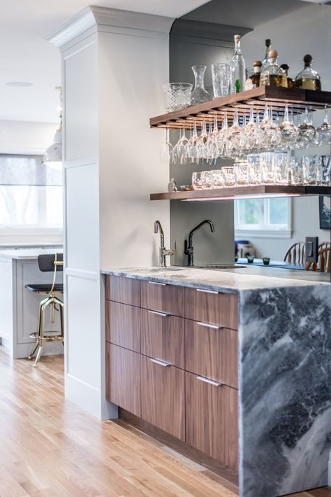 This little custom wet bar is just 18” deep by 66” long but the smoked glass backsplash, leather finish waterfall marble counter and walnut cabinets and shelves highlighted by led lights in the shelves... well, small space with big impact. Waterfall Countertop Wet Bar, Small Built In Bar, Marble Bar Counter, Mcm Basement, Dining Room Cabinets Built In, Modern Wet Bar, Built In Bar Cabinet, Bar In Living Room, Appliances In Kitchen