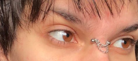 bridge piercing chain #bridgepiercing #browneyes #eyes #fashion #fashioninspo #altfashion #androgynous #piercing Nose Bridge Piercing Chain, Bridge Piercing Chain, Cute Bridge Piercing, Bridge Piercing Jewelry, Nose Bridge Piercing, Nose Peircing, September Aesthetic, Piercing Chain, Bridge Jewelry