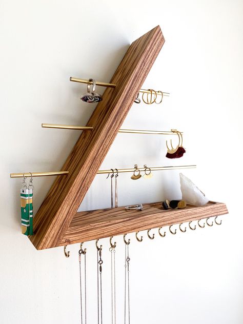 This wall mounted floating jewelry organizer is made with solid exotic zebrawood, brass rods and brass hooks. This is a modern piece with an open triangle concept. It is dowel joined with no nails or screws, keeping the aesthetics of this piece, our number one priority. There are absolutely no stains applied to our wood. We let the natural brilliance radiate with Sam Maloof poly/oil and oil/wax wood finishes. This organizer is a great platform to showcase your favorite jewelry pieces as well as Wood Jewelry Diy, Wall Mount Jewelry Organizer, Jewelry Organizer Wall, Wood Jewelery, Jewelry Wall, Zebra Wood, Small Wood Projects, Wall Organization, Jewelry Holder