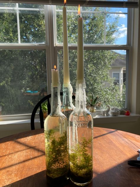 Terrarium With Candles, Wine Bottle With Candle, Witchy Spring Decor, Wine Candle Holders, Witchy Terrarium, Witchy Candle Holder, Glass Candle Holders Decorating Ideas, Wine Bottle Terrarium, Witchy Decor Witch Cottage