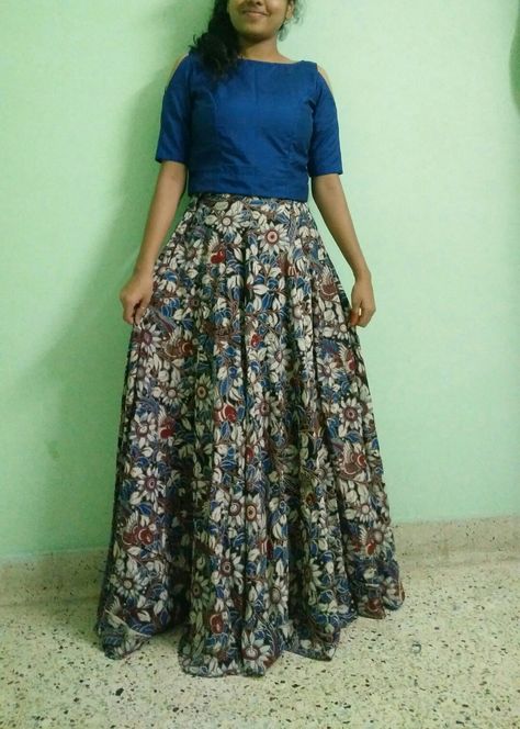 Crop top with cold shoulder and skirt. This makes me feel so cool. Good to wear for events with rich look. Kalamkari 😍😍😍😍 I'm on Instagram as @happystretchtimes. Install the app to follow my photos and videos. https://www.instagram.com/invites/contact/?i=11ab1wk2hxe2d&utm_content=iv3v8zj Kalamkari Crop Top And Skirt, Kalamkari Skirt And Top, Kalamkari Crop Top Lehenga, Kalamkari Skirts, Kalamkari Tops, Kurti Back Neck Designs, Kurthi Design, Desi Casual, Net Saree Blouse Designs