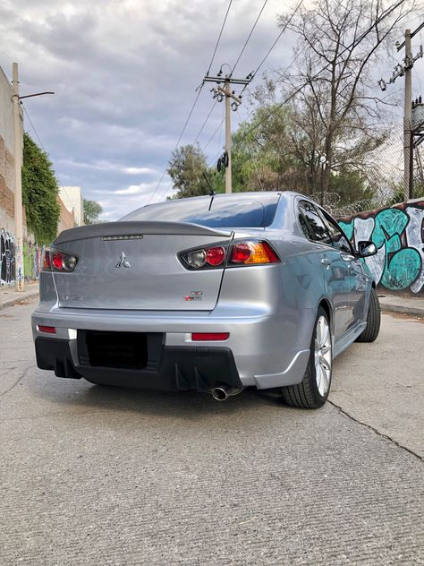 Rear bumper Mitsubishi lancer 
Jdm (Japan domestic market) 
Tuning car
Silver 
Momo wheels 
Duck bill Lancer Gt, Mitsubishi Lancer Evo, Lancer Evo, Mitsubishi Evo, Lancer Evolution, Mitsubishi Lancer Evolution, Mitsubishi Lancer, Car Stuff, Fake Story