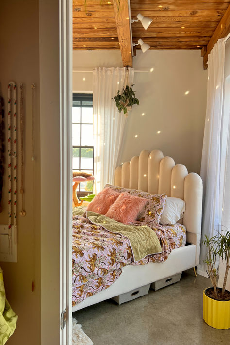 Image of a white cozy bed with tiger print bedding in a sunny loft apartment. A funky, oversized bed frame is featured while the reflection of a disco ball dances on the walls of the room. Fun Bedroom Aesthetic, Cozy Bedroom Pink, Apartment Preppy, Aesthetic Pink Bedroom, Aesthetic Cozy Room, Funky Bedroom Decor, Colorful Apartment Decor, Funky Room Decor, Quirky Bedroom