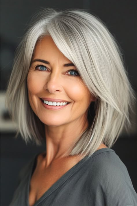 Silver Layered Lob Haircut for Women Over 50. Middle Age Bob Over 50, Lob Haircut Grey Hair, Choppy Layered Bob Straight Hair, Women’s Layered Bob, Flowy Bob Hairstyles, Shoulder Length Hair Grey, Bobs For 50 Year Old Women, Outfits For Grey Hair, Top Hairstyles For 2024