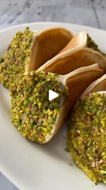 Ben Siman Tov on Instagram: "Pistachio & Cream Kataif 

You can find the full recipe on my website (link in bio 💃🏽)

Ramadan is around the corner and and it’s time to make one of my favorite snacks for this holiday. Kataif is an Arab dessert commonly served during the month of Ramadan. The name refers to a dessert as a whole and, more specifically, the batter. It is a sort of sweet loaded pancake (similar to a Scottish crumpet) filled with cream or nuts. The cream here is based on semolina with a kiss of orange blossom syrup. After preparing the pancakes, I fold them in half and fill with the cream. I then dip them in freshly ground pistachios for another layer of texture. I find that the pistachios complete the flavor profile for the whole treat. These kataif are relatively not as sweet Pistachio Pancakes, Arabic Sweets Recipes, Pistachio Cream, Month Of Ramadan, Arabic Sweets, Crumpets, Flavor Profiles, Sweets Recipes, Favorite Snack