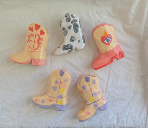 HOMEGIRL on Instagram: "do you want a cowboy boot??? They’re all up for custom orders on our etsy !! They keep selling out some i might be upping the processing…" Cowboy Boot Planter, Vase Shelf, Paintbrush Holder, Boot Planter, Painted Ceramics, Match Striker, Cerámica Ideas, Cowgirl Aesthetic, Clay Art Projects