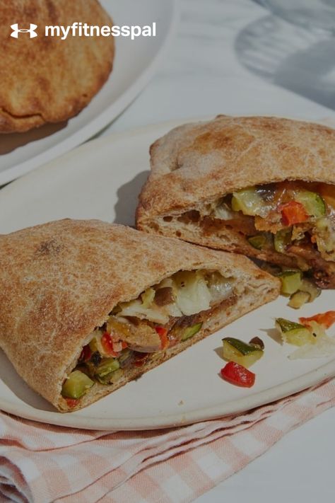 This healthy calzone recipe has all the elements of a filling meal: protein, fiber and fat, plus a serving of vegetables. The carbohydrate and protein ratio makes it great for a post-workout refuel meal. Make this healthy pizza / hot sandwich ahead of time and eat this for lunch or dinner immediately following your workout session for recovery and building muscle. #MyFitnessPal #vegetablecalzones #healthycalzone #healthycalzonerecipes #healthycalzonemeals #vegetarian Vegetarian Calzone Recipe, Veggie Calzone Recipe, Veg Calzone Recipe, Veggie Calzone, Myfitnesspal Recipes, Pizza Hot, Zucchini Banana Bread, Calzone Recipe, Vegetarian Sausages