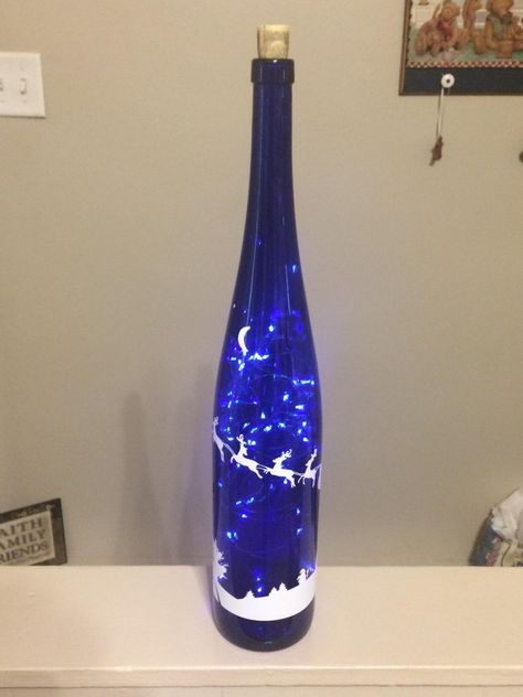 Christmas wine bottle with fairy lights. Blue Wine Bottle Crafts, Wine Bottle With Fairy Lights, Wine Bottle Crafts Christmas, Wine Bottle Project, Blue Wine Bottles, Christmas Wine Bottle, Bottle Diy Crafts, Painted Glass Bottles, Painted Bottles