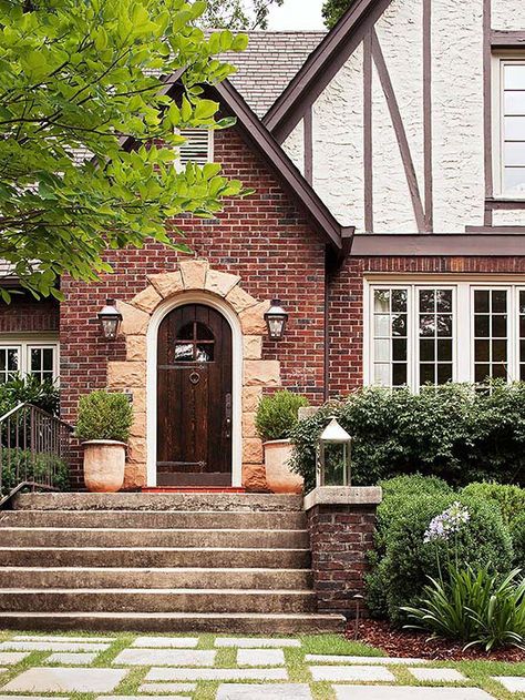 A stone-framed entry provides pleasing contrast to this home's brick exterior: http://www.bhg.com/home-improvement/door/exterior/exterior-doors-and-landscaping/?socsrc=bhgpin060314stoneaccent&page=2 Brick Siding, Storybook Homes, Elegant Doors, Tudor Style Homes, Medieval Houses, Tudor House, Casa Exterior, Exterior Cladding, Tudor Style