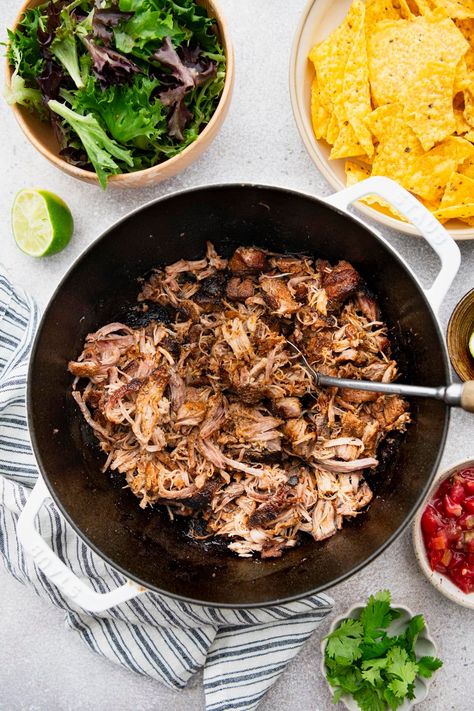 Slowly roasting pork shoulder in zesty spices with a touch of citrus in a cast iron Dutch oven yields tender, flavorful Mexican pulled pork. Serve the crispy Dutch oven carnitas in warm corn tortillas, on a fresh salad, alongside chips and guac, or on a bed of easy Spanish rice. Dutch Oven Carnitas, Oven Carnitas, Easy Spanish Rice, Chips And Guac, Spanish Rice Easy, Mexican Pulled Pork, Fresh Salad, Spanish Rice, Cast Iron Dutch Oven