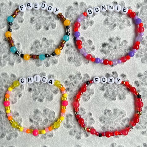 ❁ Beaded bracelets made by me ❁ FNAF Five Nights at Freddy’s inspired bracelets ❁ Made with clear stretch thread, seed beads, round beads, glow in the dark beads and letter beads ❁ Bracelet and size requests available ❁ Link to store in my bio ❁ Prices from $5 ❁ More info on my etsy and ig #fnaf #fnafbracelet #fivenightsatfreddys #foryoupage #fyp #bracelets Fnaf Friendship Bracelet, Fnaf Bracelet, Halloween Bracelet Diy, Glow In The Dark Beads, Inspired Bracelets, Diy Kandi Bracelets, Letter Bead Bracelets, Diy Kandi, Halloween Bracelet