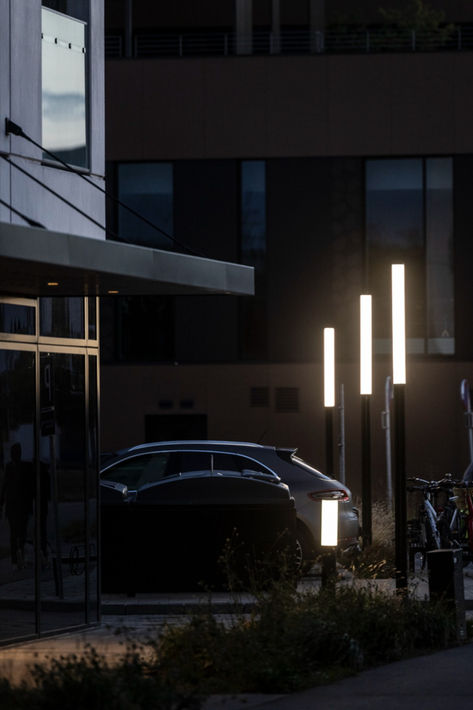 PIN pole lights illuminate a parking lot along with one PIN bollard light Parking Lot Lighting, Bollard Lighting, Parking Lot, Parking Design, Post Lights, Street Light, Danish Design, Lighting, Architecture