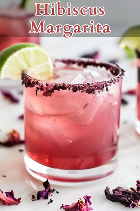 The Hibiscus Margarita is a vibrant and refreshing twist on the classic margarita, blending the bold flavors of tequila, triple sec, and lime juice with the floral and slightly tart notes of hibiscus syrup. Spicy Hibiscus Margarita, Hibiscus Margarita Recipe, Hibiscus Margarita, Hibiscus Syrup, Mezcal Margarita, Tequila Drinks, Classic Margarita, Margarita Recipe, Tequila Cocktails