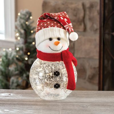 Brighten your holiday with this plush and crackle glass snowman. Includes 10 starry lights. Studio 66 | Studio 66 Frosty Top Lighting 7.2 H x 7.2 W x 9.96 D in brown / red / whiteGlass / Mercury Glass | 7.2" H X 7.2" W X 9.96" D | Wayfair Vase Snowman, Snowman Mason Jar, Allergy Medicine, Starry Lights, Glass Snowman, Snowman Christmas Decorations, Christmas Glasses, Blue Christmas Tree, Boutique Items