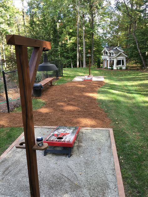 Cornhole And Horseshoe Pit, Cornhole Patio Ideas, Cornhole Horseshoe Pit, Fire Pit And Corn Hole, Build Backyard Games, Cornhole Board Playing Area, Backyard Corn Hole Court, Corn Hole Playing Area, Cornhole Area Ideas