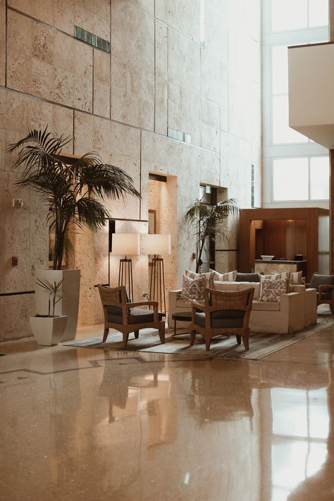 Miami Hotel Lobby, Hotel Lobby Modern Tropical Interior Design, Stone Wall Interior Living Room, Tropical Hotel Lobby, Coral Stone Wall, Beach Hotel Lobby, Historic Hotel Lobby, Stone Walls Interior, Exterior Wall Design