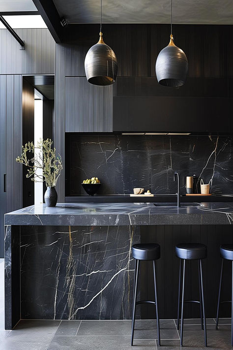 Contemporary black kitchen with bold marble countertops. Minimalist Kitchen Black Countertop, Black Countertop Black Cabinets, Black Stone Kitchen Countertops, Black Modern Interior Design, Dark Luxury Kitchen, Black Marble Kitchen Countertops, Black Countertop Kitchens, Kitchen Black Marble, Black Marble Kitchen