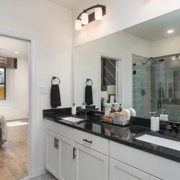 Black Floor White Cabinets Bathroom, Bathroom With White Cabinets And Black Countertop, Black Top Vanity Bathroom, Bathroom Decor Ideas Black Countertop, White Bathroom Cabinets With Black Countertops, Bathrooms With Black Granite Countertops, Black Countertop In Bathroom, Black Bathroom Vanity Black Countertop, Black Vanity Top Bathroom Ideas