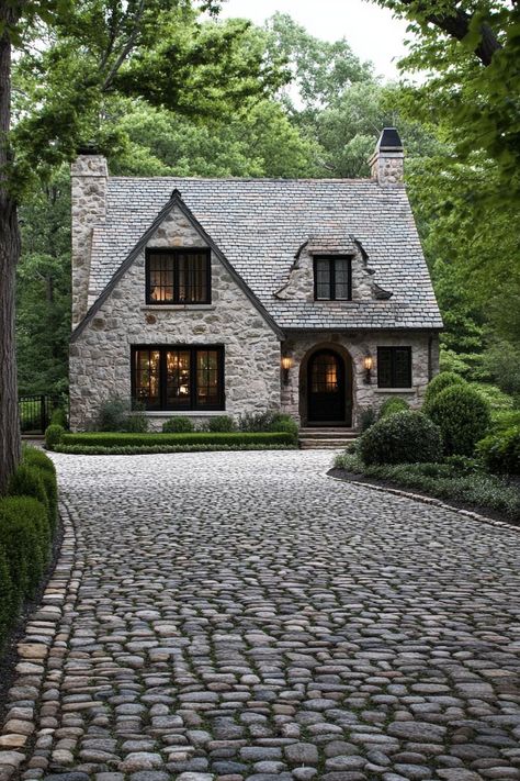 Modern English cottage front yard with cobblestone driveway lined with trees. Check out all of these modern English cottages that are as charming as they are functional. Can this be your dream home? Brick English Cottage Exterior, English Home Plans, Quaint Cottage Exterior, English Cottage Layout Floor Plans, Modern Stone Cottage Exterior, English Country Exterior Homes, English Cottage Home Exterior, English Cottage House Plans One Story, Small Stone Cottage House Plans