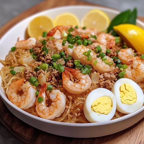 🍜 "Dive into the deliciousness of Pancit Luglug—a Filipino noodle dish that’s full of flavor and tradition!" 🍜🇵🇭 #PancitLuglug #FilipinoFood Pancit Luglug Ingredients: Rice noodles (0.5 lb) Shrimp, peeled and deveined (0.5 lb) Ground pork (0.25 lb) Garlic, minced (4 cloves) Onion, chopped (1) Annatto seeds (2 tbsp, soaked in water) Fish sauce (2 tbsp) Shrimp broth (2 cups) Hard-boiled eggs, sliced (2) Chicharron, crushed (0.5 cup) Green onions, chopped (for garnish) Lemon or calamansi wedg... Pancit Luglug, Shrimp Broth, Filipino Noodles, Annatto Seeds, Cozy Fall Recipes, Noodle Dish, Festive Drinks, Savory Dishes, Noodle Dishes