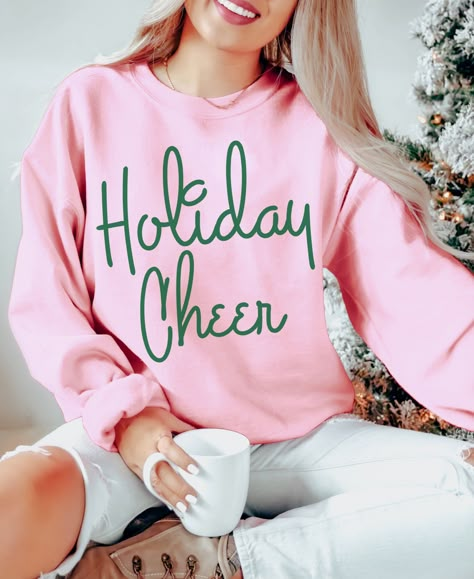 Celebrate the holidays, but make it fashion in our cozy and trendy Holiday Cheer sweatshirt. Wear it all season long to all your holiday outings, Christmas Parties, seeing Christmas lights, baking or just curled up in front of the fire at home. It also makes great Christmas gifts for the fashion lovers and minimalists on you list.  Holiday Cheer Sweatshirt, Women's Christmas Shirt, Trendy Holiday sweatshirt, Aesthetic sweatshirt, Retro Christmas shirt, gifts for her A sturdy and warm sweatshirt Vinyl Sweatshirt Ideas Cricut, Pink Christmas Sweatshirt, Cute Christmas Sweatshirts, Winter Shirt Ideas, Christmas Sweatshirts Vinyl, Holiday Sweatshirts, Christmas Shirts For Women, Retro Christmas Shirt, Aesthetic Sweatshirt