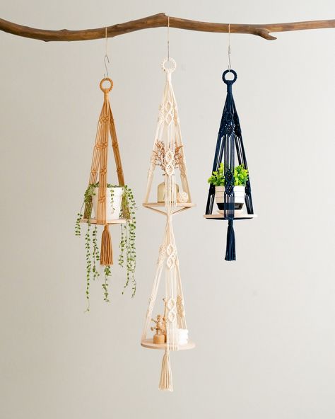 Another beautiful macrame plant hanger with a shelf is coming to town, and we couldn't be more excited to share it with you. This BeanDaikon Wooden Plant Shelf combines a sturdy wooden platform with elegant macrame plant holders. Imagine the charm it will add to your space, showcasing your favorite plants in a unique and aesthetically pleasing way. To explore this creation and many others, please visit our website by clicking the link in our bio. #BeanDaikon #MacramePlantHanger #PlantLovers... Plant Shelves Indoor, Wooden Plant Hanger, Boho Shelves, Hanging Plant Shelf, Macrame Shelf, Support Pour Plante, Hanging Plants Indoor, Farmhouse Shelves, Christmas Organization