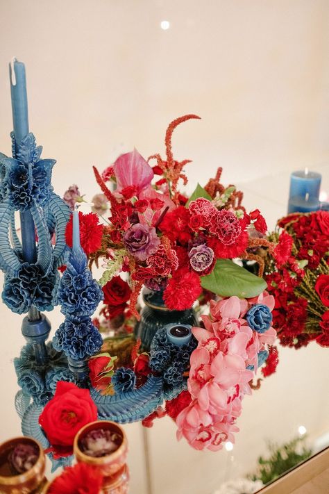 Blue Taper Candles and Red Flower Arrangement Light Blue Red Pink Wedding, Red And Blue Wedding Theme, Blue And Red Wedding, Mayakoba Mexico, Indian Beach Wedding, Blue Red Wedding, Red Flower Arrangements, Taper Candles Wedding, Tropical Wedding Reception