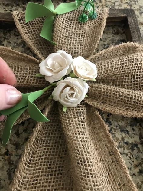 I was looking for a cross for a First Communion. There’s not many religious stores available now so I decided to make my own using a few Dollar Store items and some burlap. Materials:A Dollar Store canvas (8 x 10)GreensPaper flowersBurlapJewels (if you desire)StainGlue gun and sticksTwine We will begin by removing the canvas from the frame. I used a staple remover which made it easier. Once it’s off you can stain the wood any color you like. I used Minwax in Dark Walnut. No… Burlap Cross, Staple Remover, Sunday School Kids, Cross Wreath, Stick Crafts, Diy Picture Frames, Diy Picture, Burlap Ribbon, Paper Roses