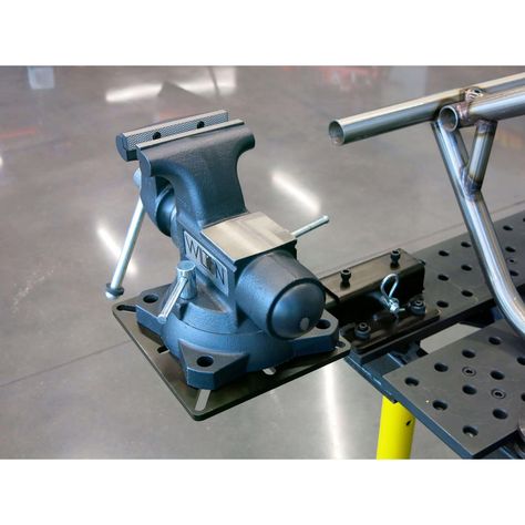 Keep your work surface clear and eliminate the need for dedicated machine stands with this handy receiver style tool mount. The receiver portion features a 6 inch square mounting surface with 5/8 diameter holes on 4 inch centers. It can be easily attached to your own workbench above or below the work surface. The hole pattern fits directly on popular Buildpro, or Certiflat welding tables. The receiver also includes four jam bolts to produce a rock-solid fit for the tool mount.  #tricktools #noju Workshop Bench, Welding Tables, Steel Doors And Windows, Cart Ideas, Welding Supplies, Welding Cart, Bench Vise, Bench Grinder, Fabrication Tools