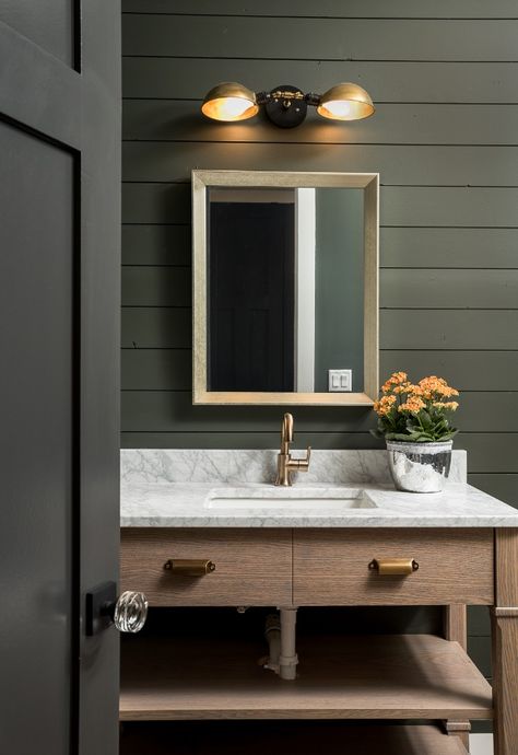 Modern rustic bathroom + black and white marble countertops + wooden bathroom cabinetry + dark green walls + dark wood doors + gold wall lighting | Picture Perfect House Bathroom Design Black, Bad Inspiration, Powder Room Design, Dark Walls, Industrial Wall Lights, Brass Wall Light, Trendy Bathroom, Rustic Bathroom, Ship Lap Walls