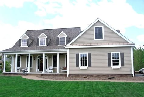 I really like the taupe siding with dark grey shutters. This is a possibility for my house. I have stone work and a blue front door. Taupe Siding With Black Shutters, Tan House Gray Shutters, Tan House White Shutters, Tan Vinyl Siding House, House Shutter Colors, Tan Siding, Vinyl Siding House, White Window Boxes, Oak Porch