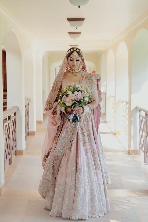 Bride in a pastel pink lehenga with a bouquet Pastel Bridal Lehenga, Blush Pink Lehenga, Pink Bridal Lehenga, Goa Wedding, Indian Bride Outfits, Anamika Khanna, Anita Dongre, Pink Lehenga, Indian Bridal Fashion