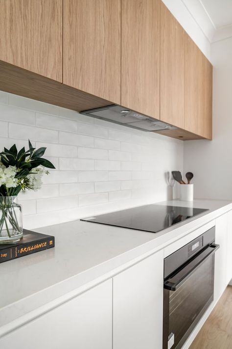 White Kitchen Dark Benchtop, Minimalist Kitchen Splashback, White And Light Timber Kitchen, Marble Bench Top Kitchen, Timber Overhead Cupboards Kitchen, Simple Kitchen Splashback, White Kitchen Benchtop Ideas, Timber Look Kitchen Cabinets, White Kitchen Timber Floor