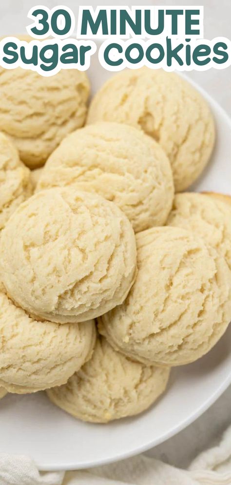 An overhead view of a plate of round circular sugar cookies stacked up on a white dish. Sugar Drop Cookie Recipe, Sugar Cookie Recipe Powdered Sugar, Powdered Sugar Cookies Recipe, Drop Cookies Recipes, Easy Drop Cookies, Drop Sugar Cookie Recipe, Powdered Sugar Cookies, Portable Dessert, Drop Sugar Cookies