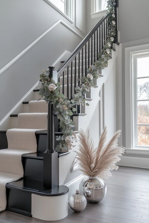 Transform your home with chic Christmas home decor. This elegant garland with silver accents enhances any staircase, adding a touch of festive magic. Perfect for making a grand entrance this holiday season! #ChristmasHomeDecor #HolidayElegance #FestiveStairs Christmas Foyer Decor, Christmas Garland Staircase, Christmas Foyer, Christmas Staircase Decor, Christmas Stairs, Christmas Staircase, Staircase Decor, Stair Decor, Minimalist Christmas