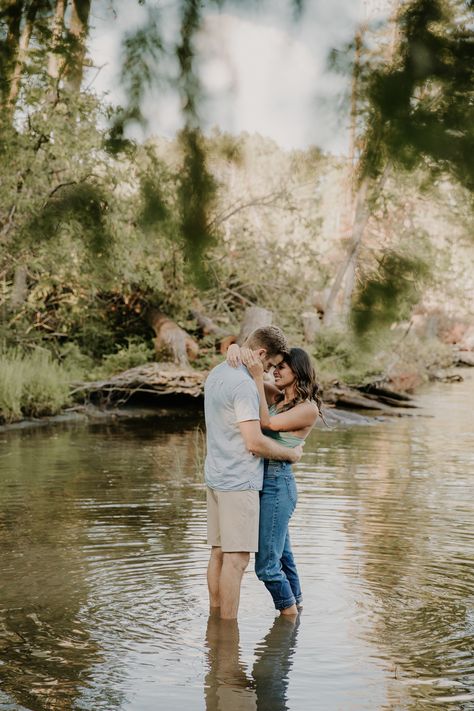 couple standing in lake for engagement photos Couples Water Photoshoot Ideas, Fall Water Engagement Pictures, Couples Photo Shoot In Water, Couples Creek Photos, Engagement Photo Water, Engagement Pictures By Water, Water Pictures Photography Couples, Couple Poses In Water, Couples Photoshoot By Water