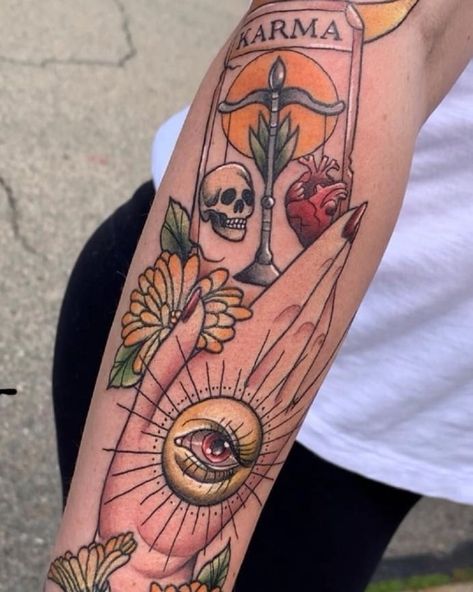 This picture is of a person standing with their right arm extended. On their arm is a neotraditional style tattoo. The tattoo is of a hand with dark res nail polish. The hand has an eye in the center of it holding a tarot card. The tarot card says the word Karma and under that word there is a scale with a heart on one side and a skull on the other. There are also Calendula flowers peeking out from behind the thumb. Traditional Tattoos Tarot Card, Karma Tarot Card Tattoo, Karma Tarot Card, Owl Feather Tattoos, Karma Tattoo, Tarot Card Tattoo, Tarot Tattoo, Inner Arm Tattoo, The Lovers Tarot