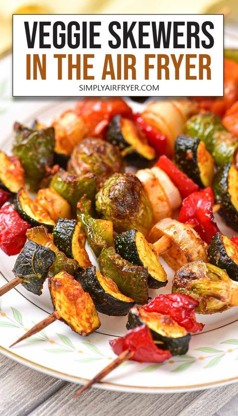 cooked vegetable skewers with zucchini, bell peppers, and other vegetables on plate with text overlay "veggie skewers in the air fryer". Vegetable Kabobs In Air Fryer, Air Fryer Kabobs, Air Fried Veggies, Vegan Kabobs, Air Fryer Vegetable, Marinated Veggies, Greek Chicken Kabobs, Veggie Kebabs, Fried Veggies