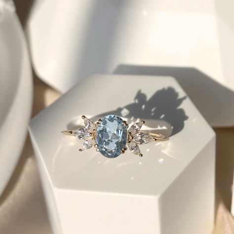 Pastel blue topaz accented with sparkle marquise cut earth mined diamonds makes this ring a breeze in the hot summer! Made to Order. Ships within 3-4 weeks. - Stone info: 1pc of 8x6 oval cut sky blue topaz 6pcs of 4x2 marquise cut natural diamonds, G-H/SI quality - Topaz ct weight: approx. 1.6ct - Diamond ct weight: approx. 0.42ctw - Total ct weight: approx. 2.02ct. - Band thickness: 1.3mm - Made in 14 karat gold. - Stamp with 14K. Blue Diamond Rose Gold Ring, Engagement Ring With Topaz, Blue Topaz Diamond Ring, Blue Topaz Marquise Ring, Diamond And Topaz Ring, Blue Topaz And Aquamarine Ring, Topaz And Diamond Engagement Ring, Baby Blue Engagement Ring, Baby Blue Wedding Ring