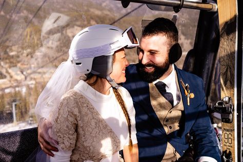 Bride and groom in a gondola during their ski elopement. The bride has on a lace dress and a veil attached to a white helmet Snowboard Wedding Ideas, Ski Lift Wedding, Ski Wedding Invitations, Ski Mountain Wedding, Ski Lift Wedding Photo, Snowboard Wedding, Bachelorette Party Veils, Colorado Snowboarding, Inexpensive Dresses